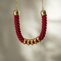 Red crocheted necklace with a grooved gold-plated arch tube | Mira