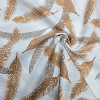 אריג כותנה דפוס נוצות בגווני כאמל אפור