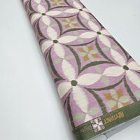 אריג קנבס דפוס פרחים אבסטרקטי גווני ירוק וסגול רך דגם קלודין