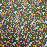 אריג כותנה דפוס פרחים שמחים על רקע ירוק דגם אתי