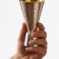 Hand Holding a Pure Silver Kiddush Cup – 