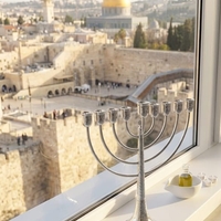 Traditional hammered Chanukah menorah made of 925 pure silver on a Jerusalem windowsill