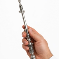 Hand holding a Torah scroll pointer, traditional filigree work made of 925 sterling silver