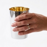 Hand holding a large, pure silver cylindrical Kiddush cup | Smooth or hand-hammered finish