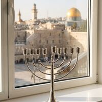 Pure Silver Menorah, Hammered Bows Model | A classically designed Hanukkah menorah on a Jerusalem windowsill