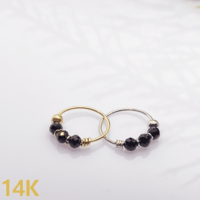 Hoop for piercing with a black-gold 14K bead