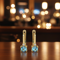 Earrings made of 14k gold set with Blue Topaz Suisse stones and diamonds model EAG36