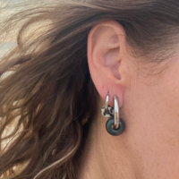 Silver hoop earrings with a green stone bead