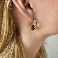 Gold plated hoop earrings with a stone bead - sparkling red