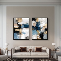 תמונת קנבס זוגית אבסטרקטית בגווני כחול, שחור ולבן עם נגיעות זהב בעיצוב מודרני