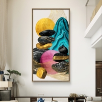 תמונת קנבס אנכית עם אבנים שחורות, טורקיז ונגיעות זהב.