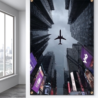 תמונת זכוכית של מטוס חולף מעל גורדי שחקים במראה אורבני דרמטי – NEXTGEN BY BAR