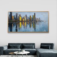 תמונת קנבס לרוחב של קו רקיע עירוני עם השתקפות במים בגווני כחול וזהב, לעיצוב סלון מודרני ואלגנטי