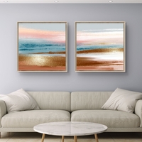 זוג תמונות קנבס מרובעות בגווני פסטל עדינים המדמים שקיעה רגועה – תכשיט לבית
