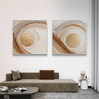 זוג תמונות קנבס מרובעות בגווני שמנת, חום וזהב עם תנועת מעגלים מודרנית – תכשיט לבית