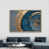 תמונת קנבס אבסטרקטית עם מעגלים בגווני כחול וזהב בהשראת חתך עץ