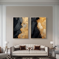 תמונת קנבס זוגית אבסטרקטית בגווני שחור וזהב בעיצוב יוקרתי לסלון