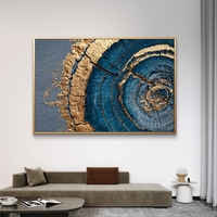 תמונת קנבס אבסטרקטית עם מעגלים בגווני כחול וזהב בהשראת חתך עץ