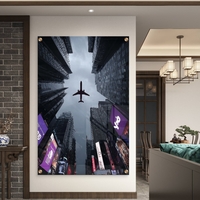 תמונת זכוכית של מטוס חולף מעל גורדי שחקים במראה אורבני דרמטי – NEXTGEN BY BAR