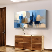 תמונת קנבס לרוחב בעיצוב אבסטרקטי עם מריחות צבע בגווני כחול, שמנת וחול, בסגנון מודרני ורגוע
