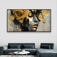 תמונת קנבס לרוחב עם דיוקן נשי דרמטי בגווני שחור וזהב ועיטורי עלי זהב
