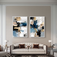 תמונת קנבס זוגית אבסטרקטית בגווני כחול, שחור ולבן עם נגיעות זהב בעיצוב מודרני