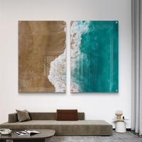 זוג תמונות זכוכית במבט על של חוף וים, מפגש בין חול חמים למים טורקיזיים בעיצוב מודרני ורגוע לקיר הבית