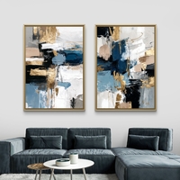תמונת קנבס זוגית אבסטרקטית בגווני כחול, שחור ולבן עם נגיעות זהב בעיצוב מודרני