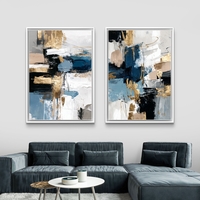 תמונת קנבס זוגית אבסטרקטית בגווני כחול, שחור ולבן עם נגיעות זהב בעיצוב מודרני