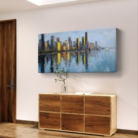 תמונת קנבס לרוחב של קו רקיע עירוני עם השתקפות במים בגווני כחול וזהב, לעיצוב סלון מודרני ואלגנטי