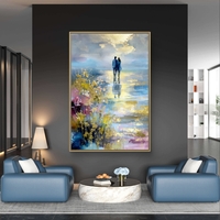 תמונת קנבס אומנותית של זוג עומד מול מים ושמיים בגוונים כחולים וזהב עם מראה ציורי ועדין