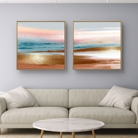 זוג תמונות קנבס מרובעות בגווני פסטל עדינים המדמים שקיעה רגועה – תכשיט לבית