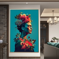 תמונת קנבס של פרידה קאלו בפרופיל אומנותי עם פרחים צבעוניים על רקע כחול, מתוך קולקציית NEXTGEN BY BAR מבית תכשיט לבית.