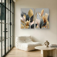 תמונת זכוכית זוגית עם עלים בגווני זהב, שמנת ושחור בעיצוב אלגנטי ומודרני