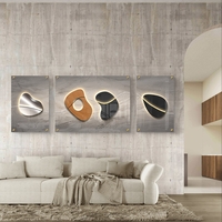 סט תמונות זכוכית מחולקות בעיצוב אבסטרקטי מודרני עם צורות אורגניות, קו מואר וגווני אפור, שחור ועץ בסלון מעוצב