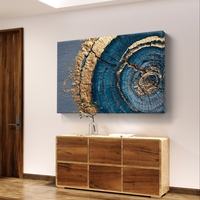 תמונת קנבס אבסטרקטית עם מעגלים בגווני כחול וזהב בהשראת חתך עץ