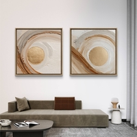 זוג תמונות קנבס מרובעות בגווני שמנת, חום וזהב עם תנועת מעגלים מודרנית – תכשיט לבית