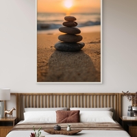 תמונת קנבס של ערימת אבנים על חוף ים בשקיעה רכה – קולקציית NEXTGEN BY BAR