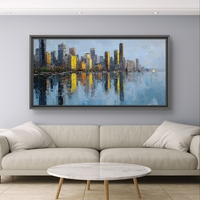 תמונת קנבס לרוחב של קו רקיע עירוני עם השתקפות במים בגווני כחול וזהב, לעיצוב סלון מודרני ואלגנטי