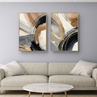 זוג תמונות קנבס מופשטות בגווני שחור, זהב וחום בהיר עם משיחות צבע רחבות בעיצוב מודרני