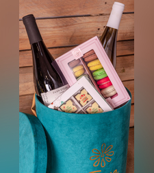French chocolate box with two bottles of wine and macaroons 
