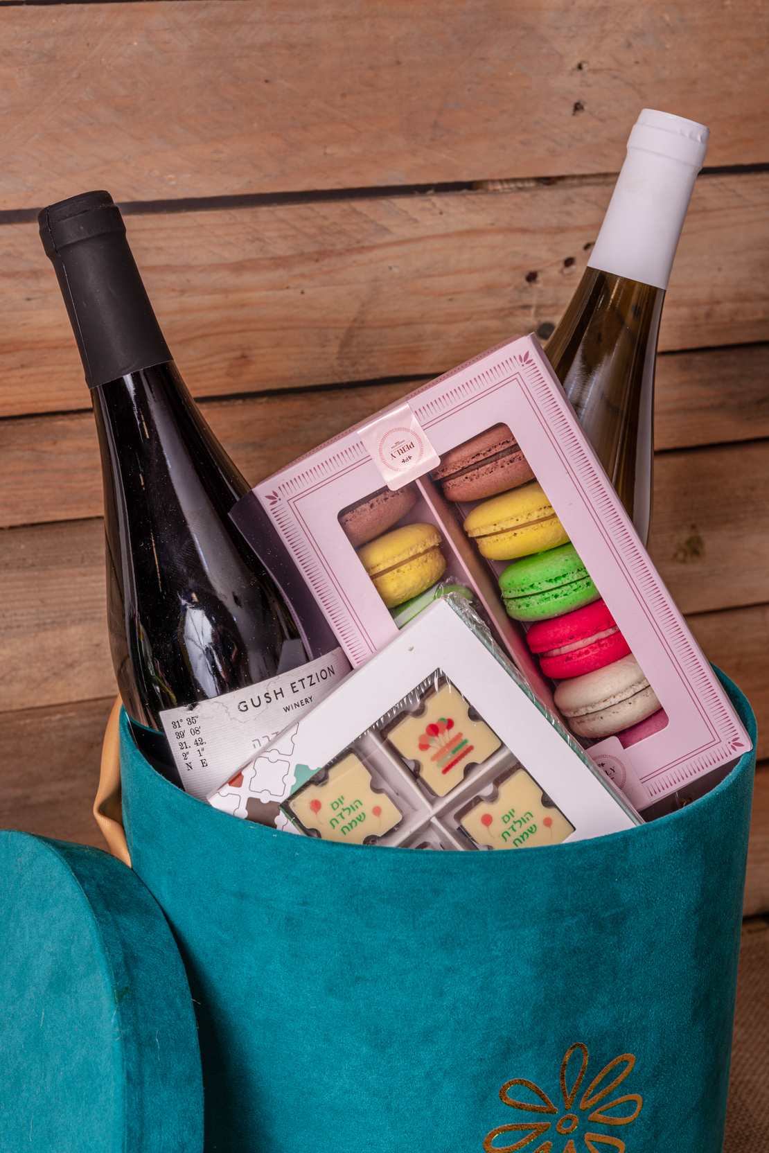 French chocolate box with two bottles of wine and macaroons 