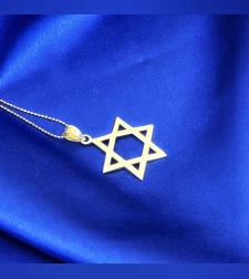 A large smooth 14k yellow gold Star of David pendant by designer Toni Roitman