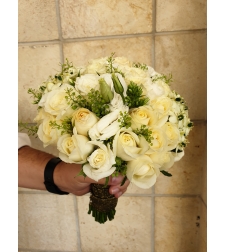 A white bridal bouquet with roses and lisianthus