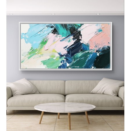 תמונת קנבס צבעונית מופשטת בגווני ירוק, ורוד ותכלת, תלויה מעל ספה מודרנית בגווני בז’.