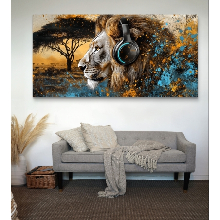 תמונת קנבס רוחבית של אריה מרשים עם אוזניות על רקע סוואנה אפריקאית, בשילוב צבעי כחול וזהב, תלויה מעל ספה ירוקה בסלון מודרני.