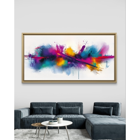 תמונת קנבס פנורמית צבעונית בסגנון מופשט עם התפרצות של צבעים עזים בגווני ורוד, טורקיז, סגול וצהוב על רקע לבן, תלויה מעל ספת בד מודרנית בגוון אפור כהה.