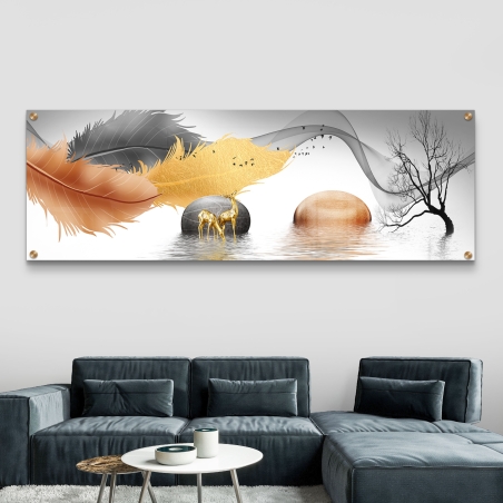 תמונה פנורמית על זכוכית עם עלים בגווני כתום, זהב ואפור, איילים מוזהבים, עץ חשוף ואבנים המשקפות במים, תלויה מעל ספה בהירה מודרנית.