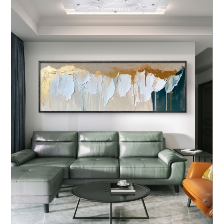 תמונת קנבס פנורמית בגוונים של זהב, תכלת ושמנת עם טקסטורה מרשימה, תלויה מעל ספה בהירה בסלון מודרני.