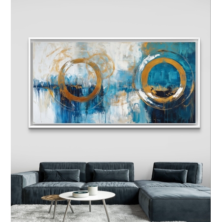 תמונת קנבס מופשטת לרוחב עם שני מעגלים בגווני כחול עמוק, לבן וזהב, בעיצוב אומנותי מודרני לקיר הסלון.